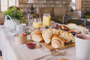 a table with a plate of croissants and other food at Casas de Campo Villa D'Almeida in Travancinha