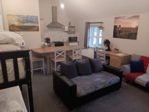 a living room with a couch and a kitchen with a table at Matty's Pub - Apartment's in Carlow