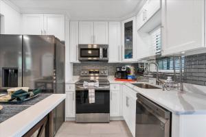 a kitchen with white cabinets and stainless steel appliances at 509 W Olympia in Punta Gorda
