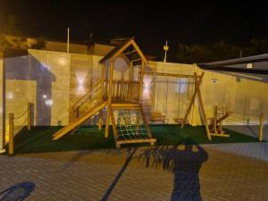 a playground with a slide in front of a building at Casa em Acaú/ Pitimbu PB in Pitimbu