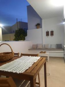 a living room with a bench and a table at Konstantza's Elegant Apartment in Naxos Chora +29 photos