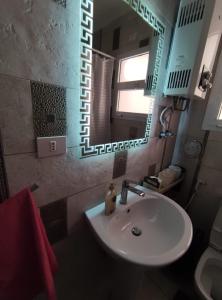 a bathroom with a sink and a mirror at Madinty Modern 2 rooms apartment at Madinty city for families only مدينتي in Madinaty
