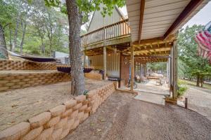 an exterior view of a house with a tree at Lake Eufaula Cabin with Hot Tub and Large Deck in Stigler