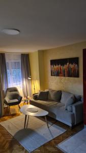 a living room with a couch and a table at Sweet heart apartment Manja in Novi Sad