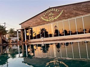 a building with a pool of water in front of it at Paradice Hotel Luxury Suites-Near zorbas Beach-FREE Breakfast in Stavros