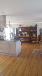 a large kitchen and living room with a wooden floor at Home away from home in Mildenhall