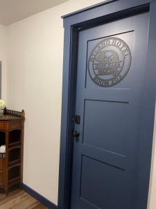 a blue door with a sign on it at Duncklee Room 202, Hyland Hotel in Palmer