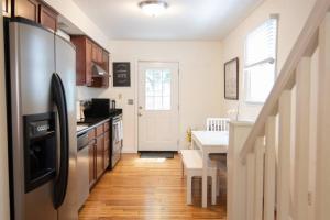 a kitchen with a stainless steel refrigerator and a table at Cozy 2br home w/ parking in downtown Annapolis in Annapolis