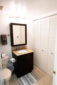 a bathroom with a sink and a toilet and a mirror at Cozy 2br home w/ parking in downtown Annapolis in Annapolis