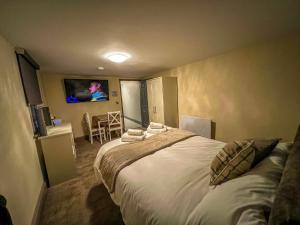 a bedroom with a bed and a tv on the wall at Grant House in Boston