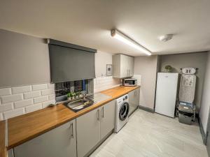 a kitchen with a sink and a refrigerator at Grant House in Boston