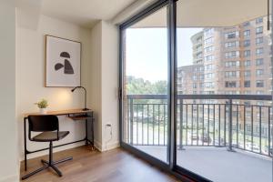 an office with a desk and a large window at Unique Luxury Apt with Rooftop @Pentagon City in Arlington