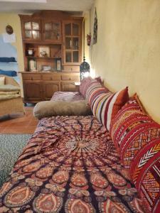 a living room with two beds and a rug at Hachazuelas7 in Moralzarzal