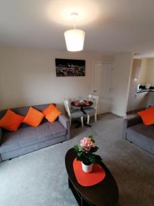 a living room with a couch and a table at Apollo Avenue Apartment in Stony Stratford