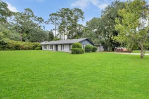 a house with a large lawn in front of it at Cozy - Organic Modern - Bungalow - FSU in Tallahassee