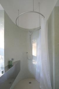 a bathroom with a shower with a shower curtain at baumhaus buchengrün in Dobl-Zwaring