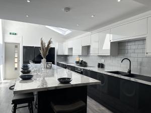 a kitchen with a table with wine glasses on it at We House - Selly Oak Birmingham in Birmingham