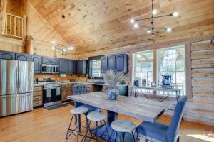 a kitchen with a large wooden table and chairs at Peaceful Whitley City Cabin on 10 Wooded Acres! in Whitley City
