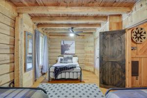 a bedroom with two beds in a log cabin at Peaceful Whitley City Cabin on 10 Wooded Acres! in Whitley City