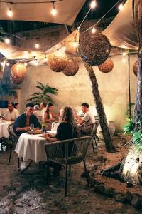 a group of people sitting at a table in a restaurant at Terasu Riviera Maya Hotel & Spa, en Xcaret in Playa del Carmen