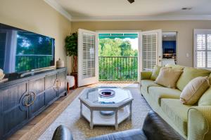 a living room with a couch and a tv at Greensboro Condo Rental Near Hospital and Trails! in Greensboro