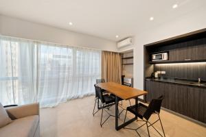 a living room with a wooden table and chairs at La Vie Suite Madero in Buenos Aires