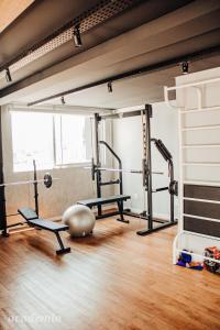 a gym with two treadmills and a ball on the floor at Loft próximo a Vila Germânica 604 in Blumenau