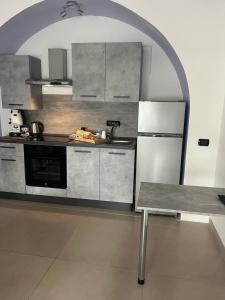 a kitchen with a table and a refrigerator at Duomo family house in Naples