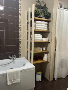 a bathroom with a white tub and a sink and towels at Duomo family house in Naples