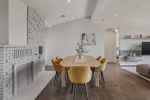 a dining room with a table and chairs and a fireplace at Breathtaking Hollywood Hills Vacation Home in Los Angeles