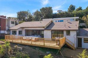 a home with a large wooden deck at Breathtaking Hollywood Hills Vacation Home in Los Angeles