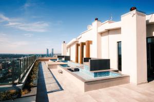 a view of a building with a tv on a balcony at Sleek Flat in Kagithane with Terrace in Istanbul