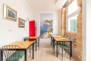 a dining room with tables and chairs and a window at Mallorca Can Florit in Sencelles