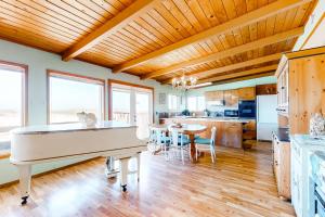 a kitchen and dining room with a white piano at Sea Mist in Rockaway Beach