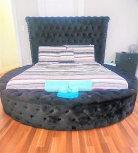 a bed with a large black bed frame in a room at CasaAzul-2605B-Beach & Pleasure Pier a block away in Galveston