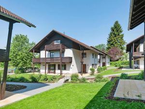 a house with a green yard in front of it at Apartment in Neuschönau near Bavarian Forest in Neuschönau