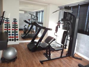 a gym with several tread machines in a room at Compact Tambaú 408 in João Pessoa