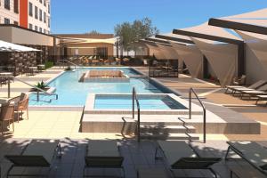a rendering of a swimming pool with tables and chairs at Fairfield by Marriott Inn & Suites Tempe in Tempe