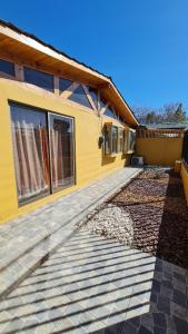 een geel huis met ramen en een oprit bij Casa Los Andes in Los Andes