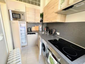 a kitchen with a sink and a stove top oven at Beautiful & peaceful apartment with cute balcony in Prague