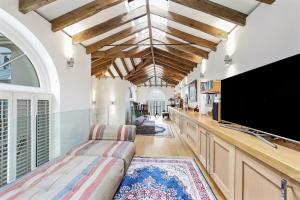 a living room with a large flat screen tv at LONDON ONE BED ANNEX in London