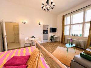 a living room with a bed and a couch at Beautiful & peaceful apartment with cute balcony in Prague