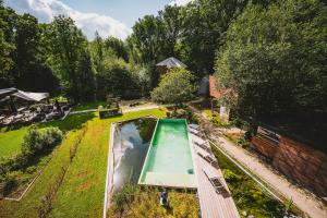an overhead view of a swimming pool in a garden at Utopia Village - Art & Nature Lodges in Jurbise