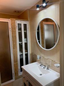 a bathroom with a sink and a mirror at Urban Pulse in San Miguel de Tucumán