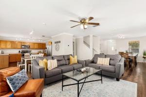 a living room with a couch and a table at Private Heated Pool & Hot Tub, 4BR Gameroom in San Antonio