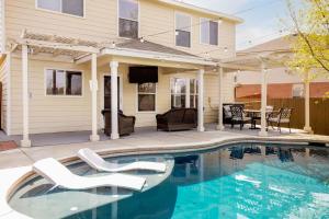 a house with a swimming pool in front of a house at Private Heated Pool & Hot Tub, 4BR Gameroom in San Antonio