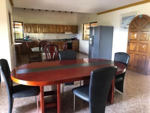 eine Küche mit einem Tisch und Stühlen sowie einem Kühlschrank in der Unterkunft Finca hotel boutique en el peñol in Guatapé