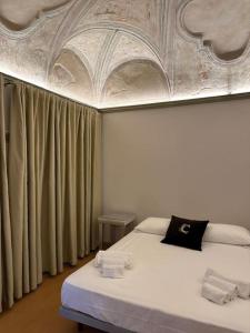 a room with two beds and a ceiling at I Tre Re, arte e storia. in Fossombrone