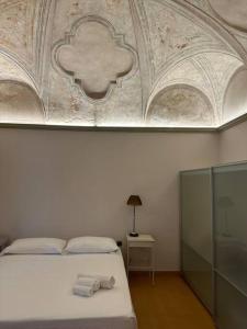 a bedroom with a bed with two towels on it at I Tre Re, arte e storia. in Fossombrone +9 photos