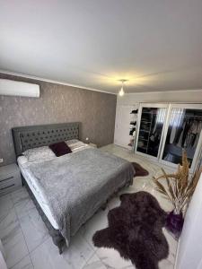 a bedroom with a large bed with rugs on the floor at Paparis in Alanya